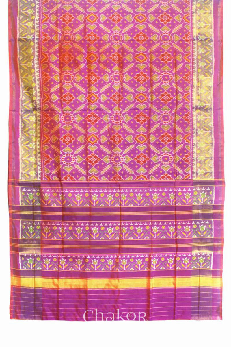 Full view of Handloom Pink Rajkoti Patola Ikat Mulberry Silk Saree with tissue borders, and mauve pallu woven using traditional designs in Gujarat.