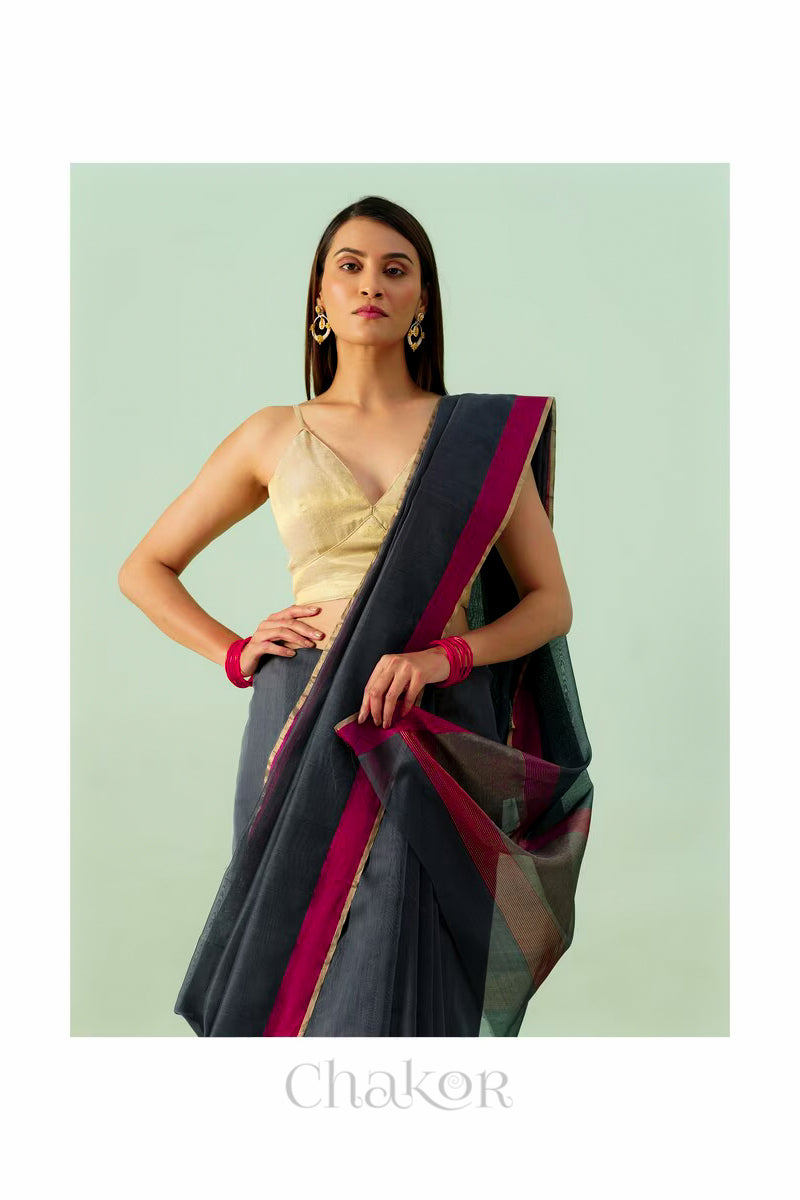 Model wearing a Black Chanderi silk cotton saree with tissue pallu and Ganga Jamuna borders, handwoven in Chanderi.