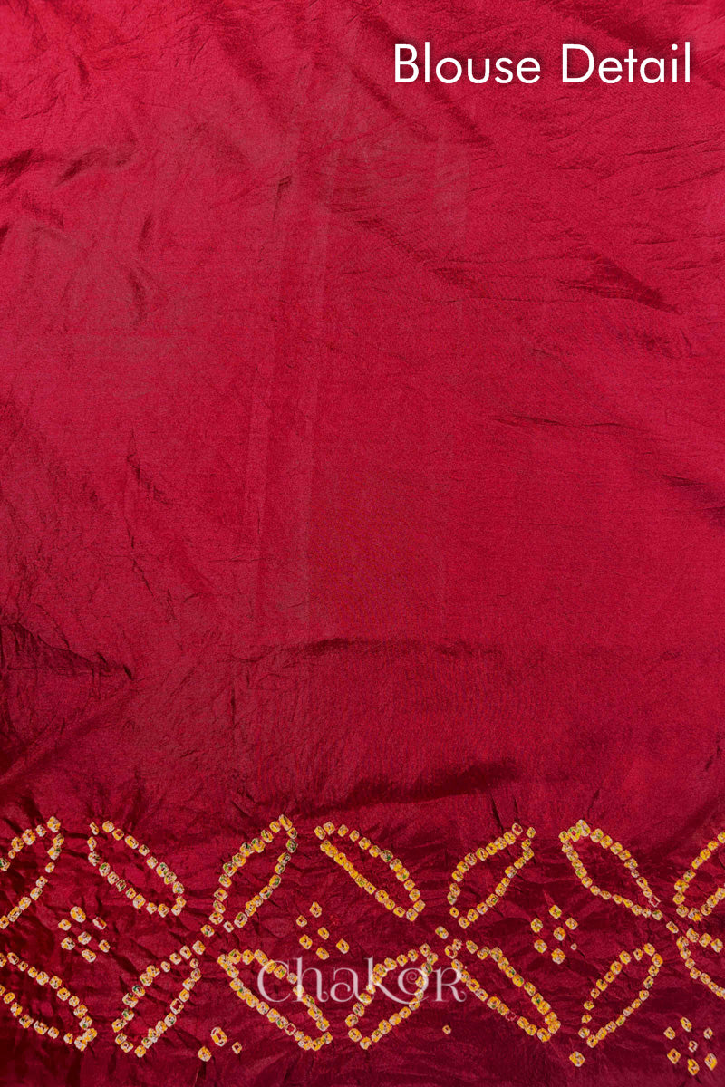 Blouse detail of Red Bandhani Mulberry Silk Saree handcrafted with yellow bandhej dots and mirror embroidery.