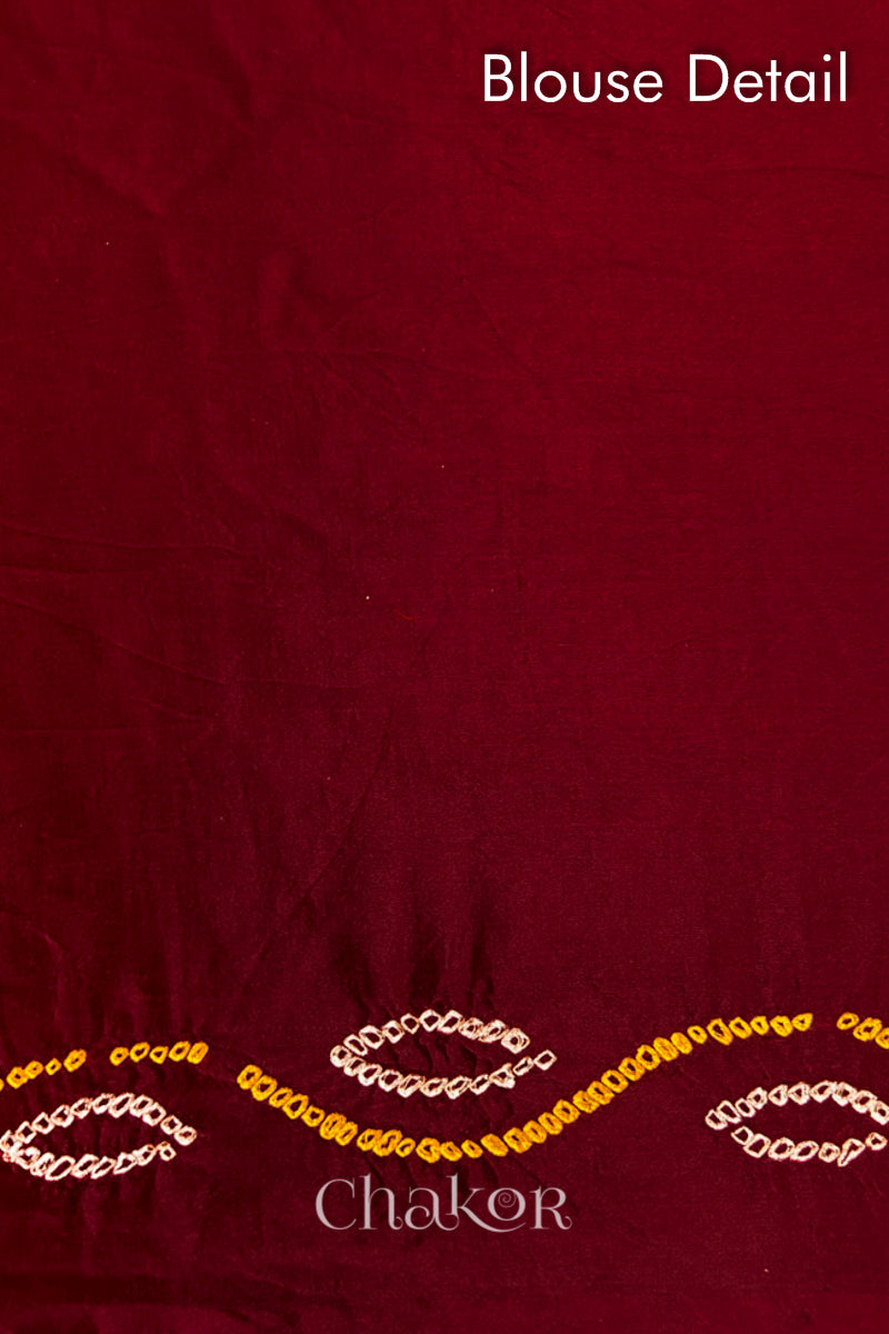 Blouse fabric detail of Handcrafted Maroon Bandhani Gaji Silk Saree with traditional rai bandhej patterns and mukaish embroidery.