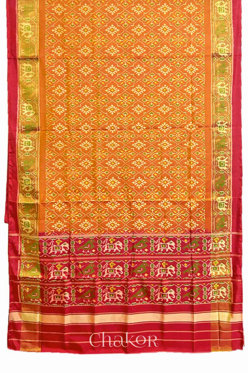 Full view of of Handloom Rust Rajkoti Patola Ikat Mulberry Silk Saree with Red borders & pallu, woven using traditional designs in Gujarat.