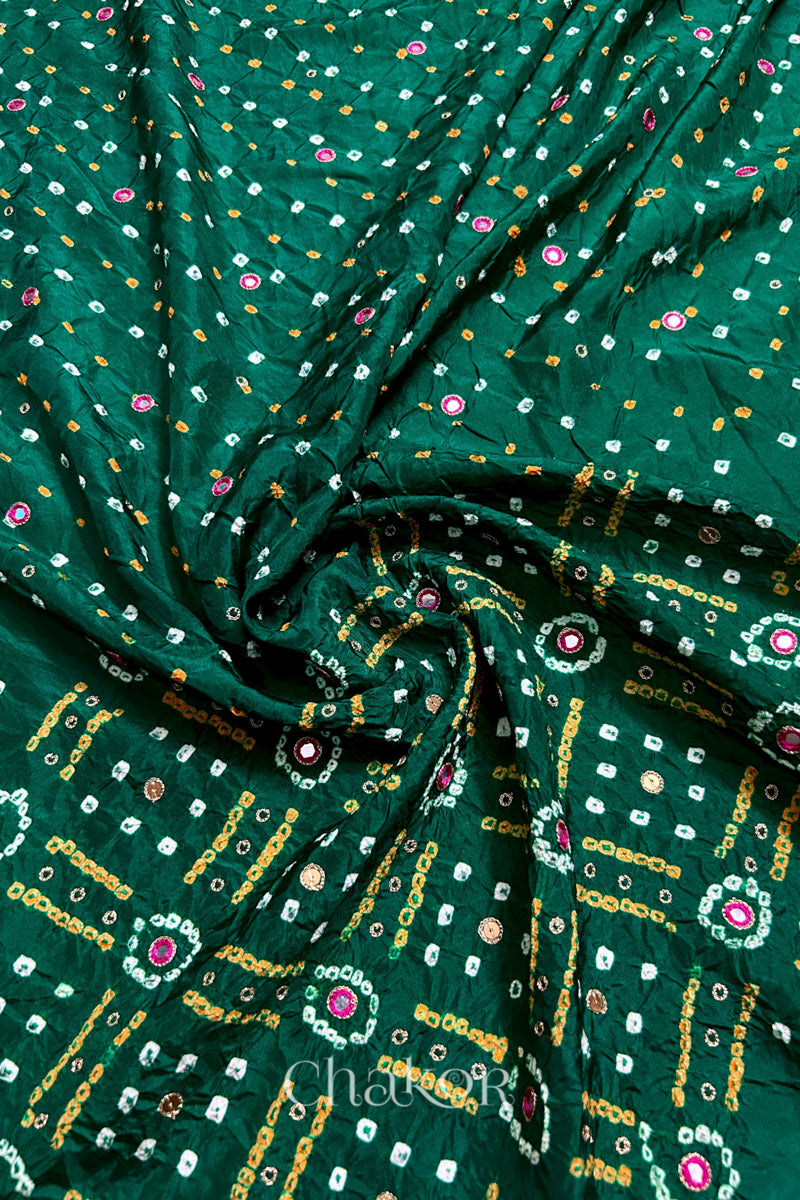 Green mulberry silk Bandhani (Rai Bandhej) fabric with white and yellow tie-dyed motifs, pink mirror and sequin embellishment, arranged in a swirling design – CHAKOR.