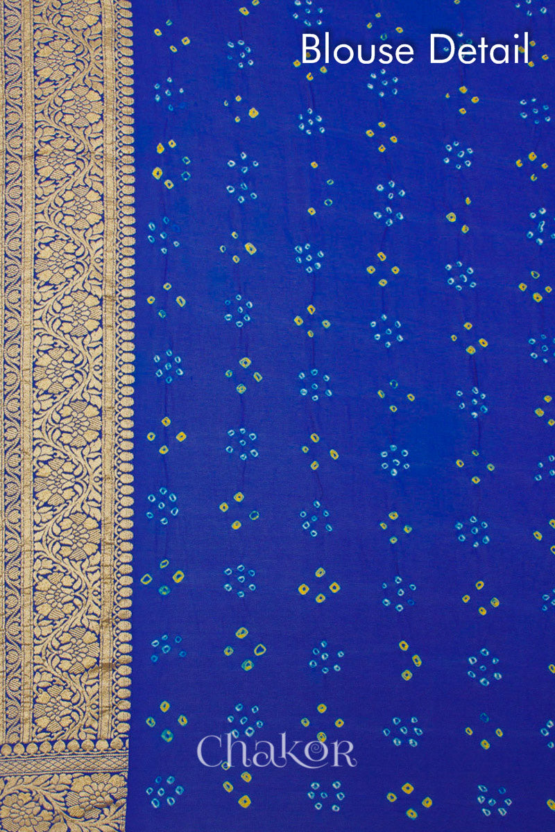 Close up of Handcrafted Peacock Blue Bandhani Banarasi Georgette Silk Saree featuring zari weaving and Kutch rai bandhej.
