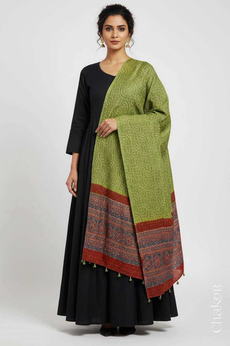 Model wearing leaf green Bandhani gaji silk dupatta with Ajrakh border and brick red pallu.