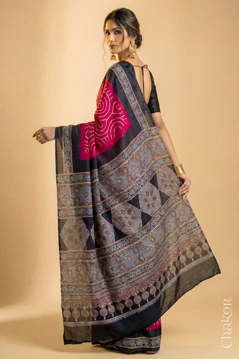 Woman wearing Red Bandhani Saree with Black Ajrakh printed border and pallu in pure gaji silk with traditional bandhej tie-dye, handcrafted in Kutch.