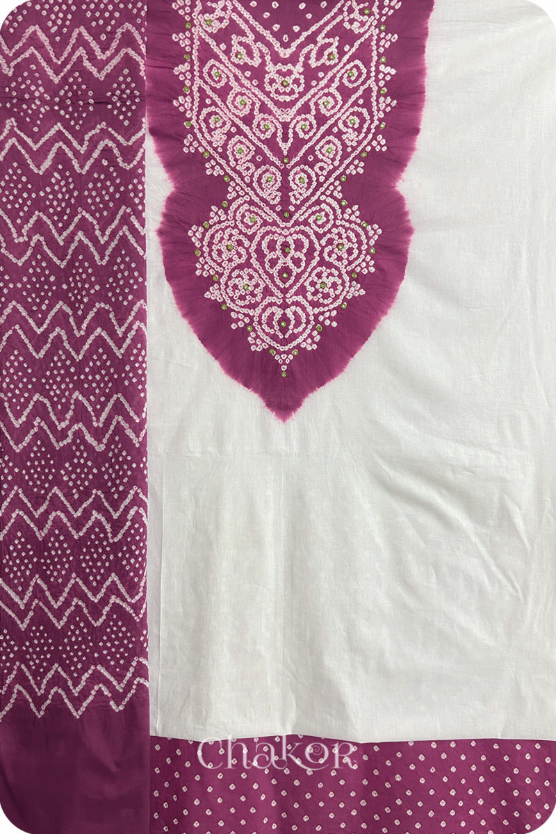 A deep violet- white kurta set fabric with intricate bandhani & mirror embroidery, paired with a deep violet bottom & odhani featuring a zigzag design.