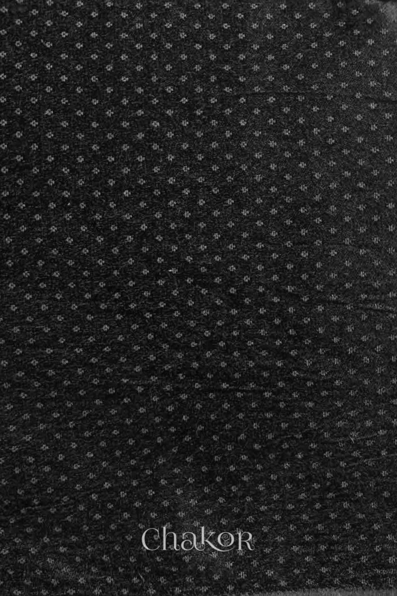 Black mashru self textured fabric with 'Chakor' logo visible.