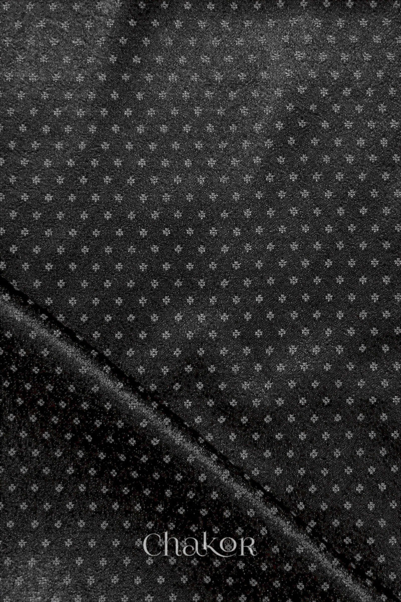 Black mashru self textured fabric with 'Chakor' logo visible.