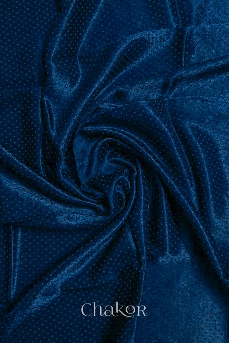 Close-up of navy mashru self textured fabric arranged in a swirling design with 'Chakor' logo visible.