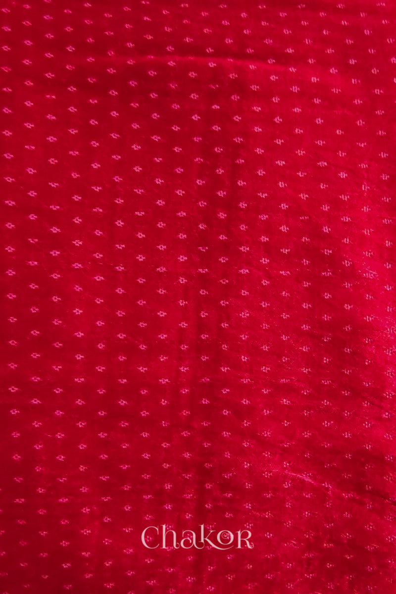 Red mashru self textured fabric with 'Chakor' logo visible.