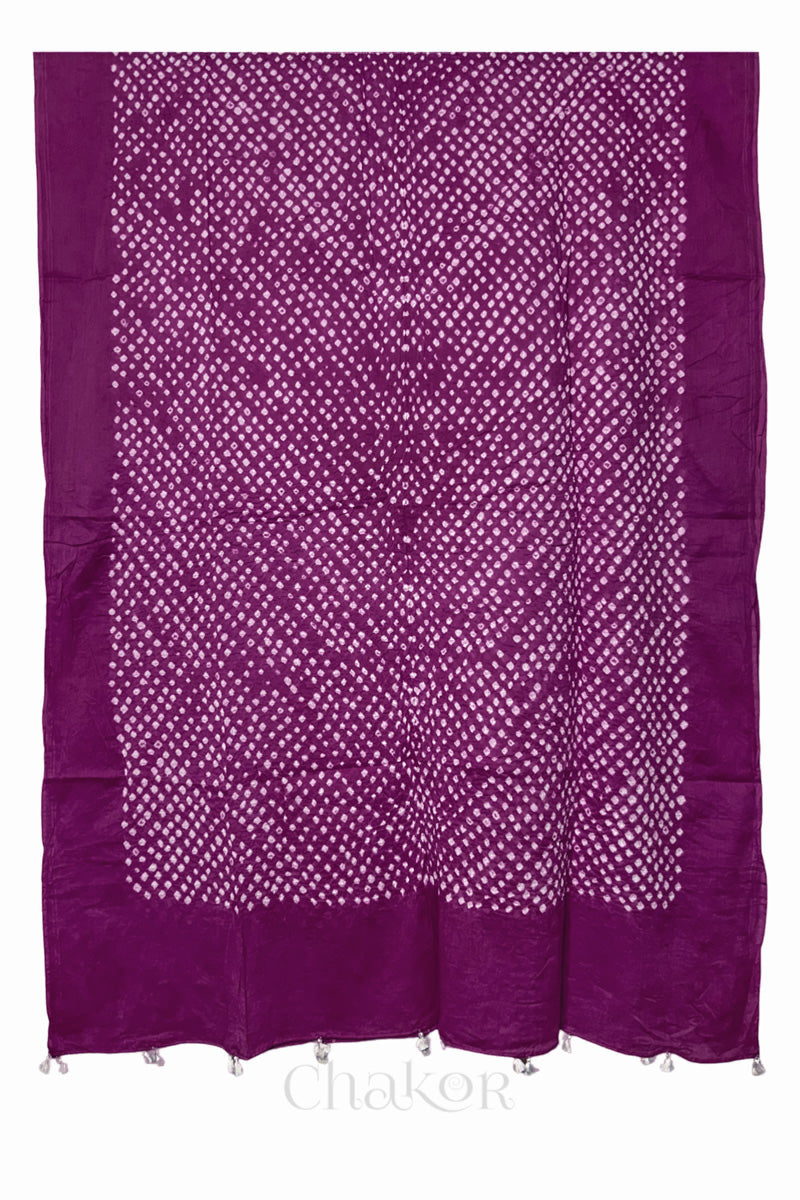 Chakor's magenta cotton mul mul dupatta with white bandhani pattern, edged with tassels at the edge.
