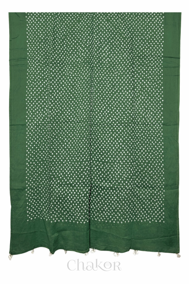 Chakor's moss green cotton mul mul dupatta with white bandhani pattern, edged with tassels at the end.
