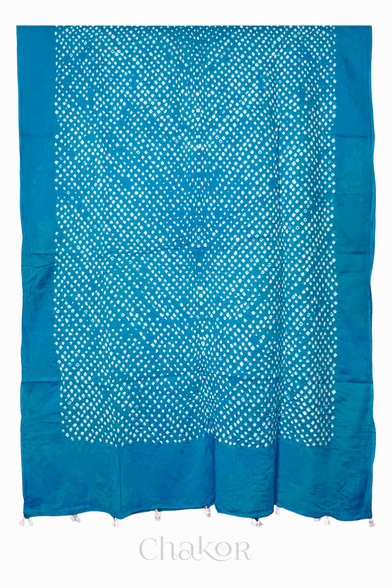 Chakor's turquoise blue cotton mul mul dupatta with white bandhani pattern, edged with tassels at the end.