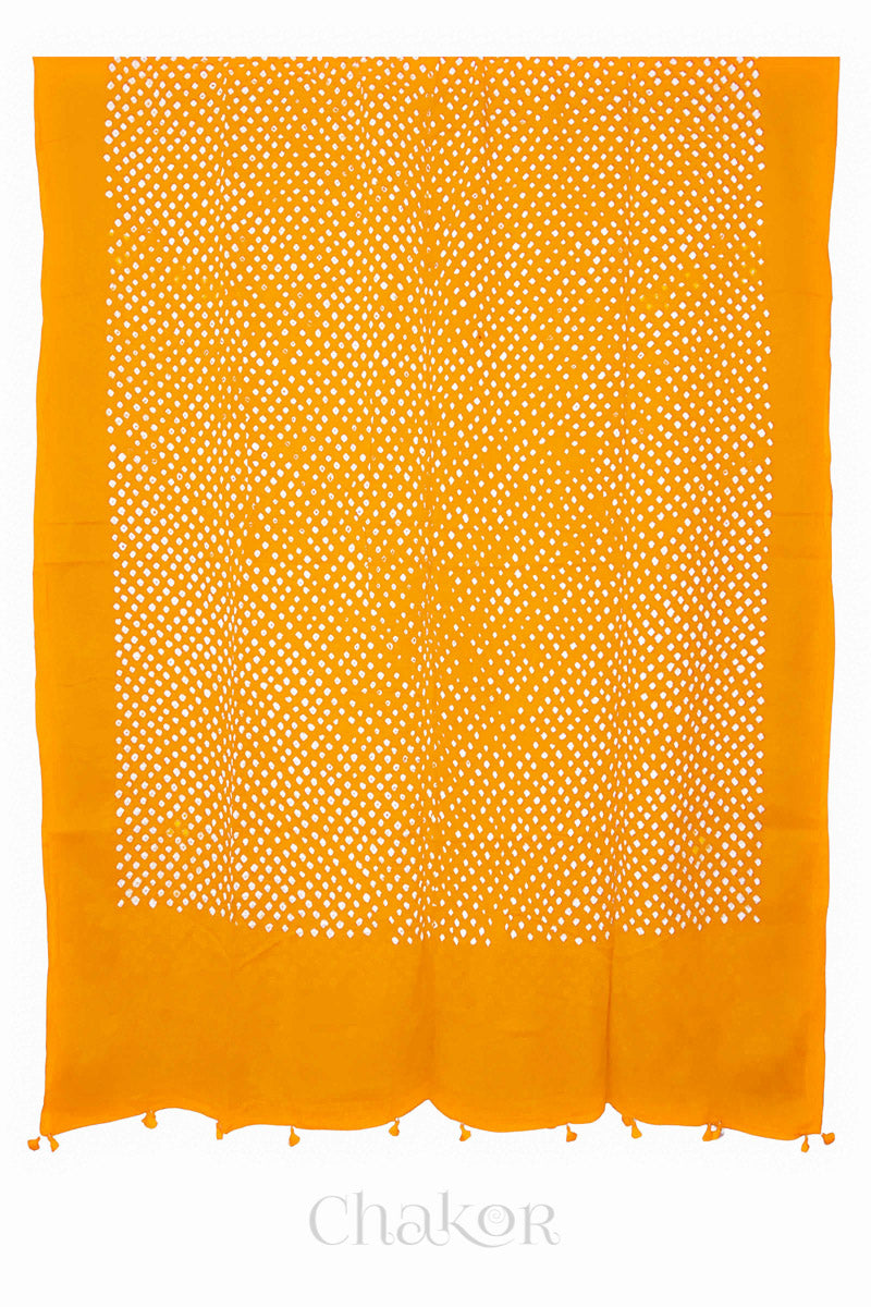 Chakor's yellow cotton mul mul dupatta with white bandhani pattern, edged with tassels at the end.