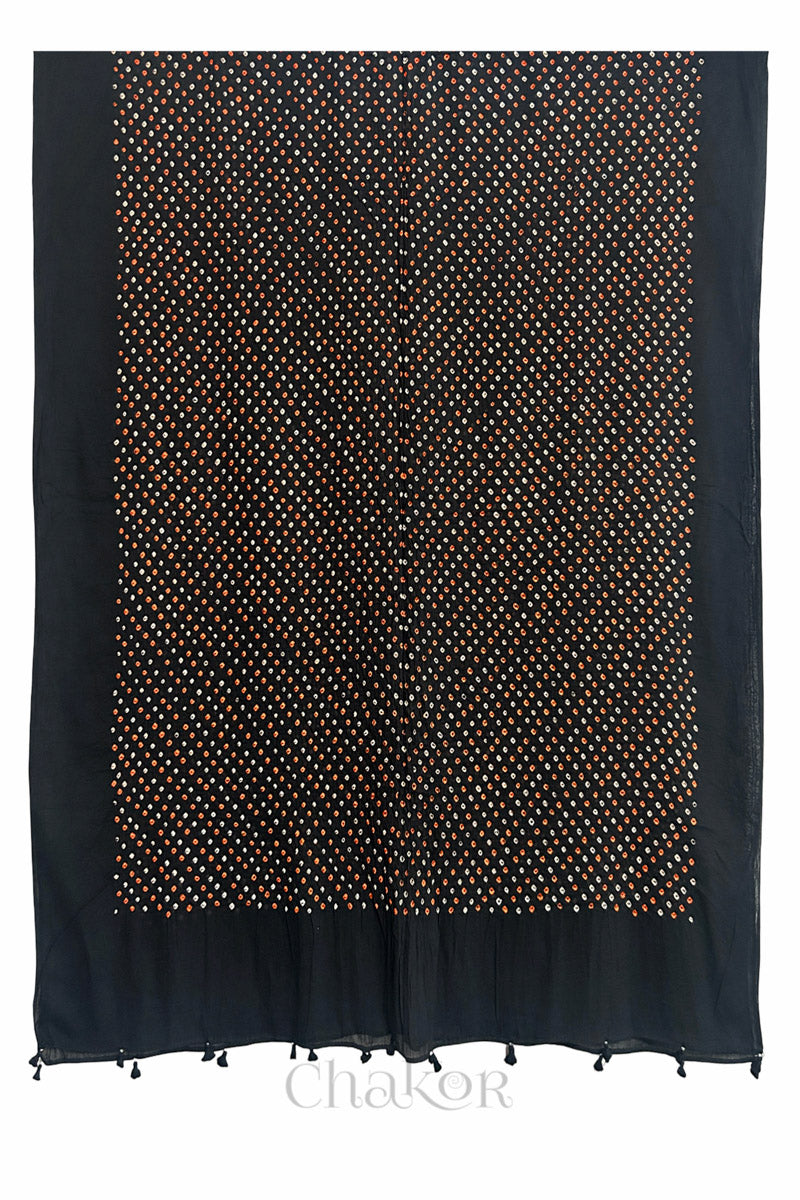 Full length view of intricate white and orange Bandhani dot pattern on Black Mulmul cotton fabric by CHAKOR.