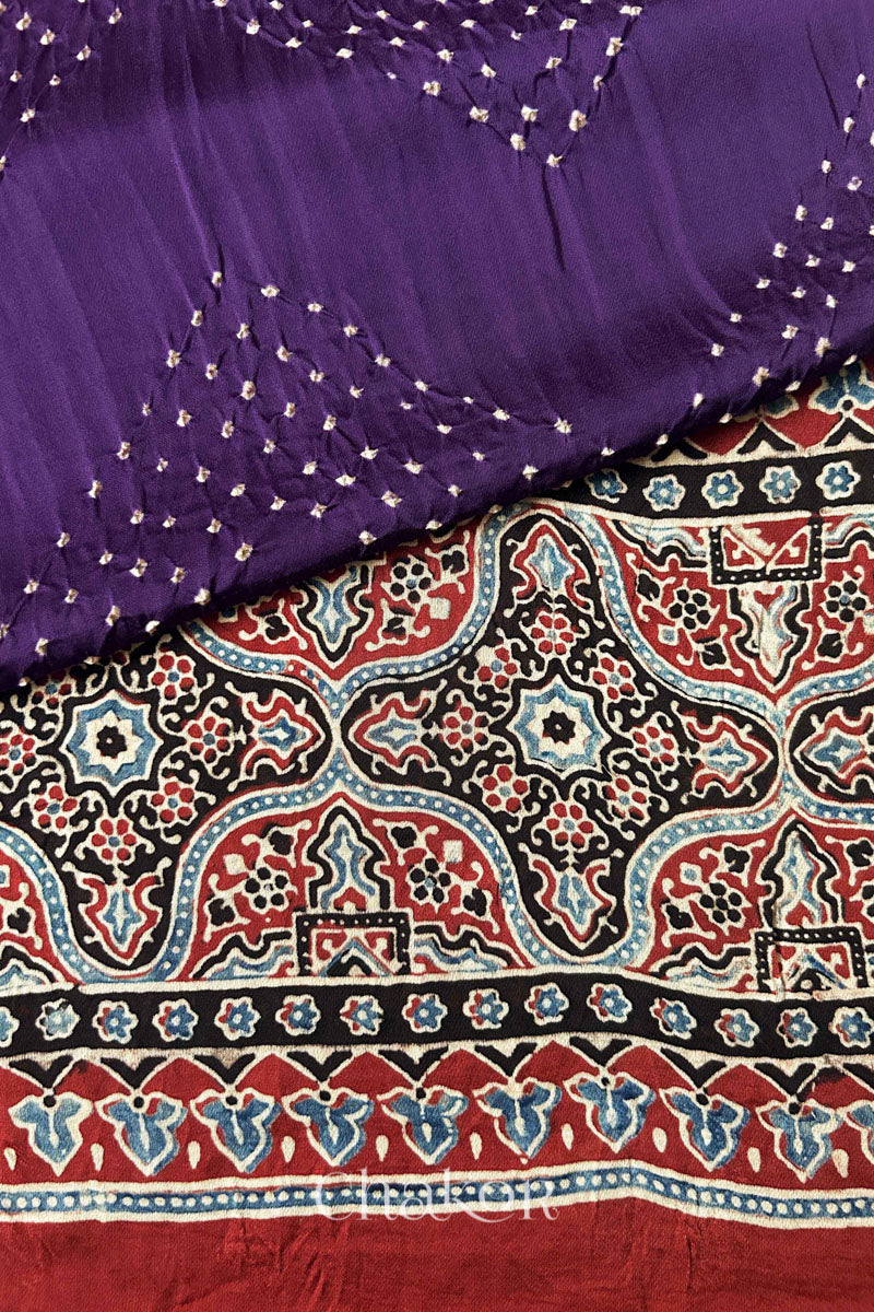 Hand tied Purple Bandhani patterns on modal stole with contrast Manjistha Red Ajrakh pallu detail.