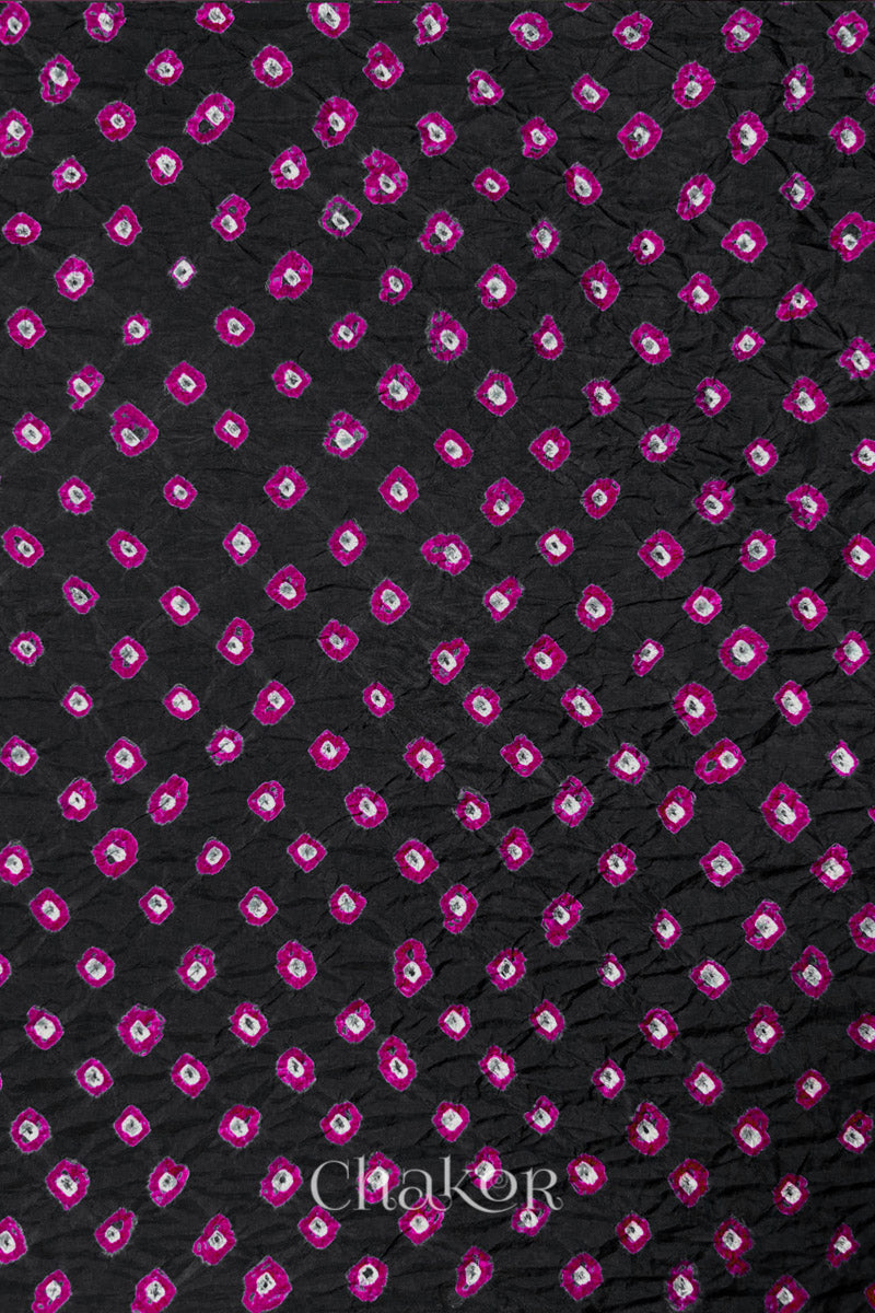 Black Mulberry silk fabric showcasing dual colour Pink bandhani patterns and Chakor brand watermark.