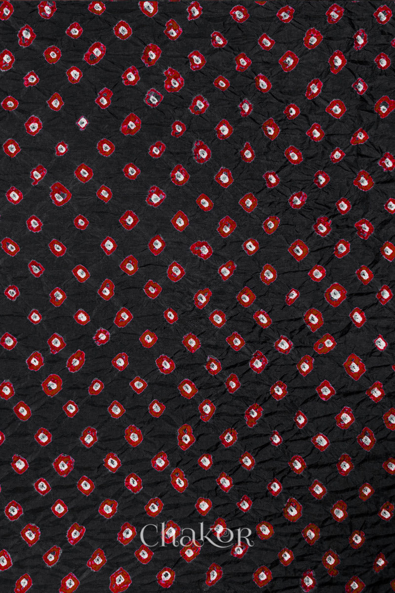 Black Mulberry silk fabric showcasing dual colour Red bandhani patterns and Chakor brand watermark.
