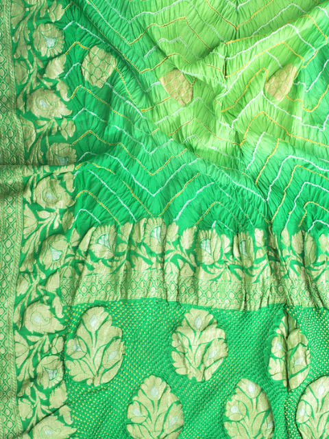 Green Bandhani saree with floral motifs by CHAKOR.
