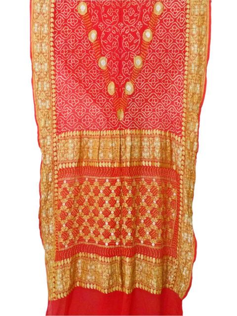 Red Bandhani saree with gold detailing by CHAKOR.

