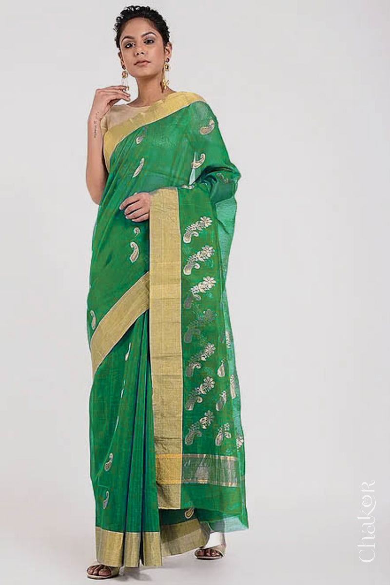 Model wearing Green Chanderi Silk Cotton Saree with paisley and floral pattern handwoven in zari.