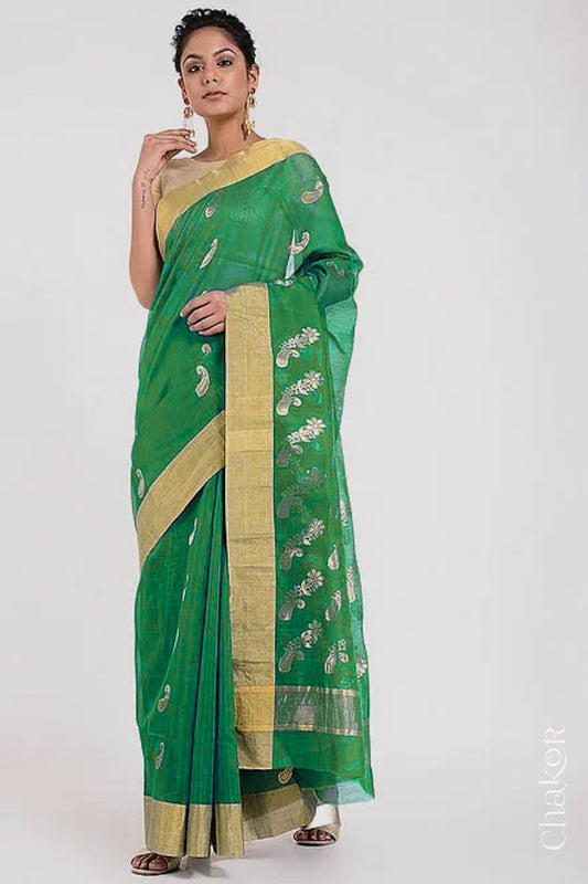 Model wearing Green Chanderi Silk Cotton Saree with paisley and floral pattern handwoven in zari.