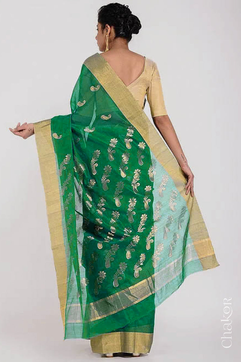 Model wearing Green Chanderi Silk Cotton Saree with paisley and floral pattern handwoven in zari.