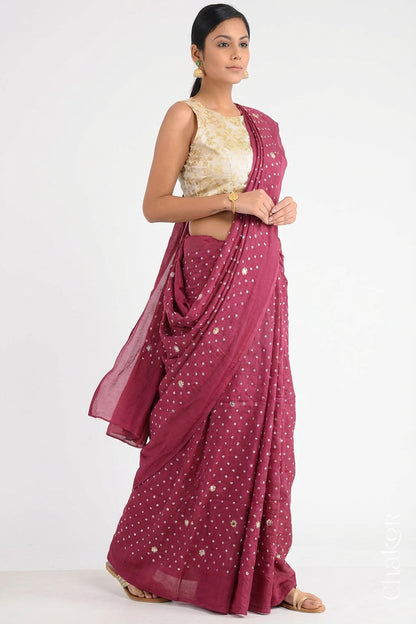 Woman wearing Dusty Red Bandhani Mulberry Pure Silk Saree, with handcrafted rai bandhej patterns using traditional tie-dye techniques from Kutch.
