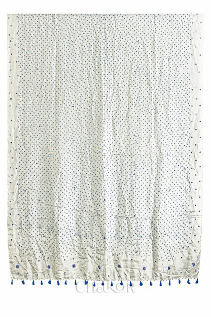 Full view of off white Bandhani mulberry silk dupatta with tie-dye dot pattern & detailed with Mirror work & tassels.