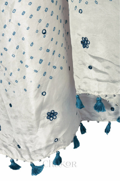 close up of off white Bandhani mulberry silk dupatta with tie-dye dot pattern & detailed with Mirror work & tassels.