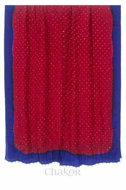 Full view of red & navy border Bandhani mulberry silk dupatta with tie-dye dot pattern & detailed with Bead edging.