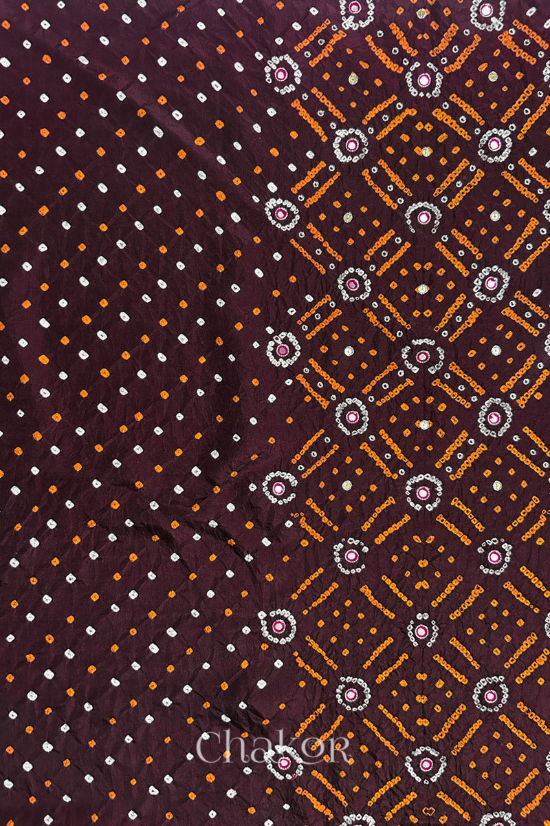 Maroon mulberry silk Bandhani (Rai Bandhej) fabric showing full layout with white and yellow tie-dye dots, traditional bandhej pattern, and zari embroidered pink mirror work & sequins embellishments – CHAKOR.
