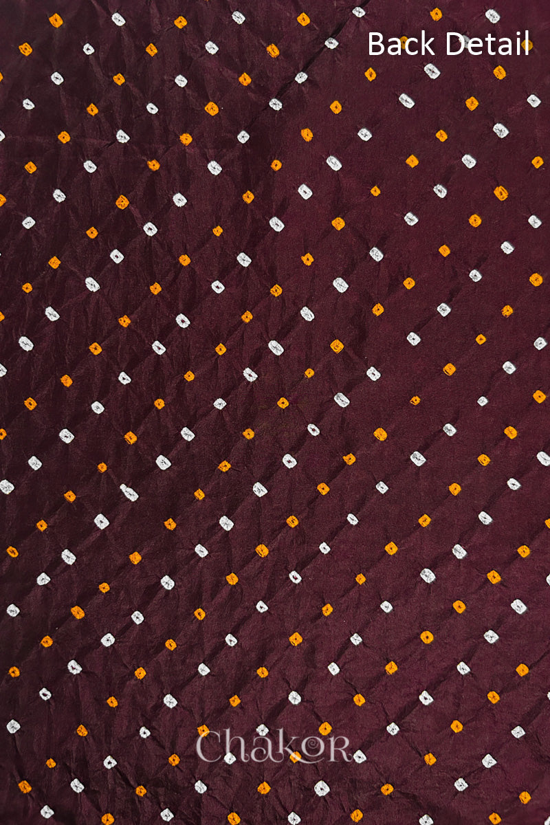 Back detail of Maroon mulberry silk Bandhani (Rai Bandhej) fabric with white and yellow tie-dye dots in an all-over pattern – CHAKOR.

