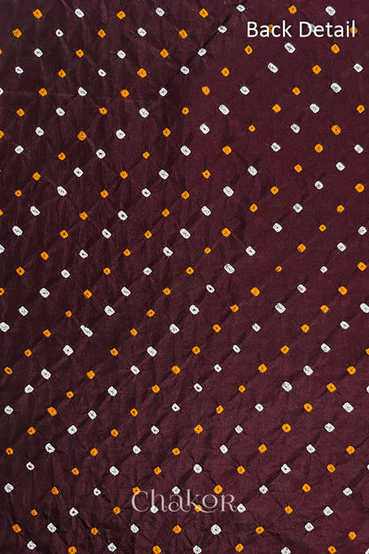 Back detail of Maroon mulberry silk Bandhani (Rai Bandhej) fabric with white and yellow tie-dye dots in an all-over pattern – CHAKOR.
