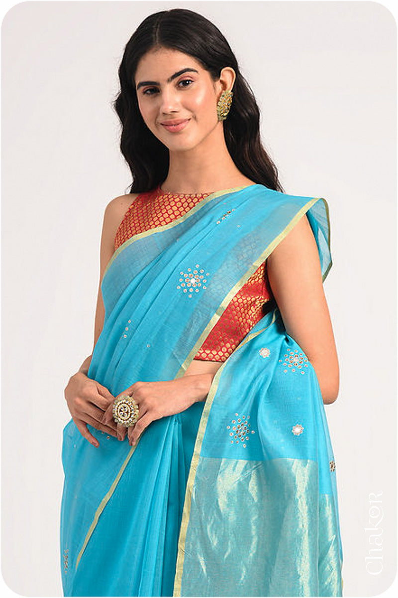 Chakor's Peacock Blue Handloom Silk Cotton Saree with woven tissue pallu & delicate sequin work buttis.