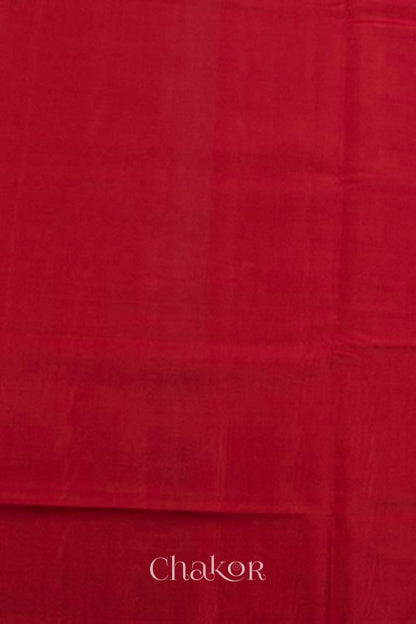 Blouse material of Handloom Orange Rajkoti Patola Ikat Mulberry Silk Saree with red borders pallu, woven using traditional designs in Gujarat.