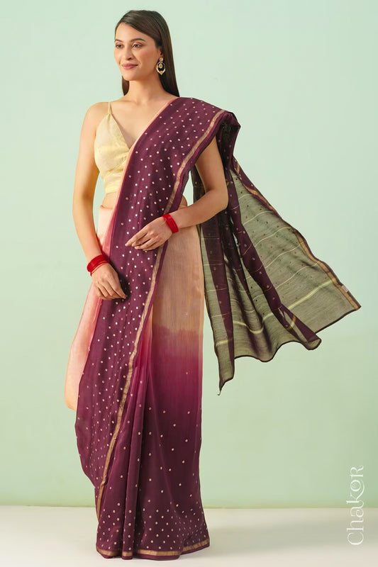 Model wearing a peach maroon shaded Chanderi silk cotton saree with hand-embroidered sequin and zari details.
