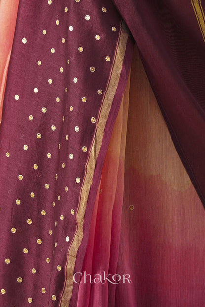 Close-up of hand-embroidered sequin and zari work on peach maroon Chanderi silk cotton saree.
