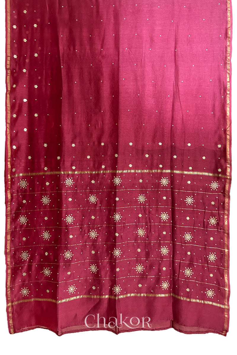 Flat view of pink plum shaded Chanderi silk cotton saree showing ombre transition and border finish.
