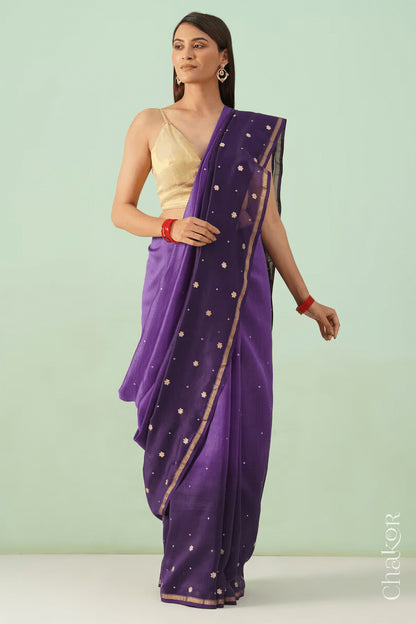 Model standing in violet purple shaded Chanderi silk cotton saree highlighting the handloom drape.
