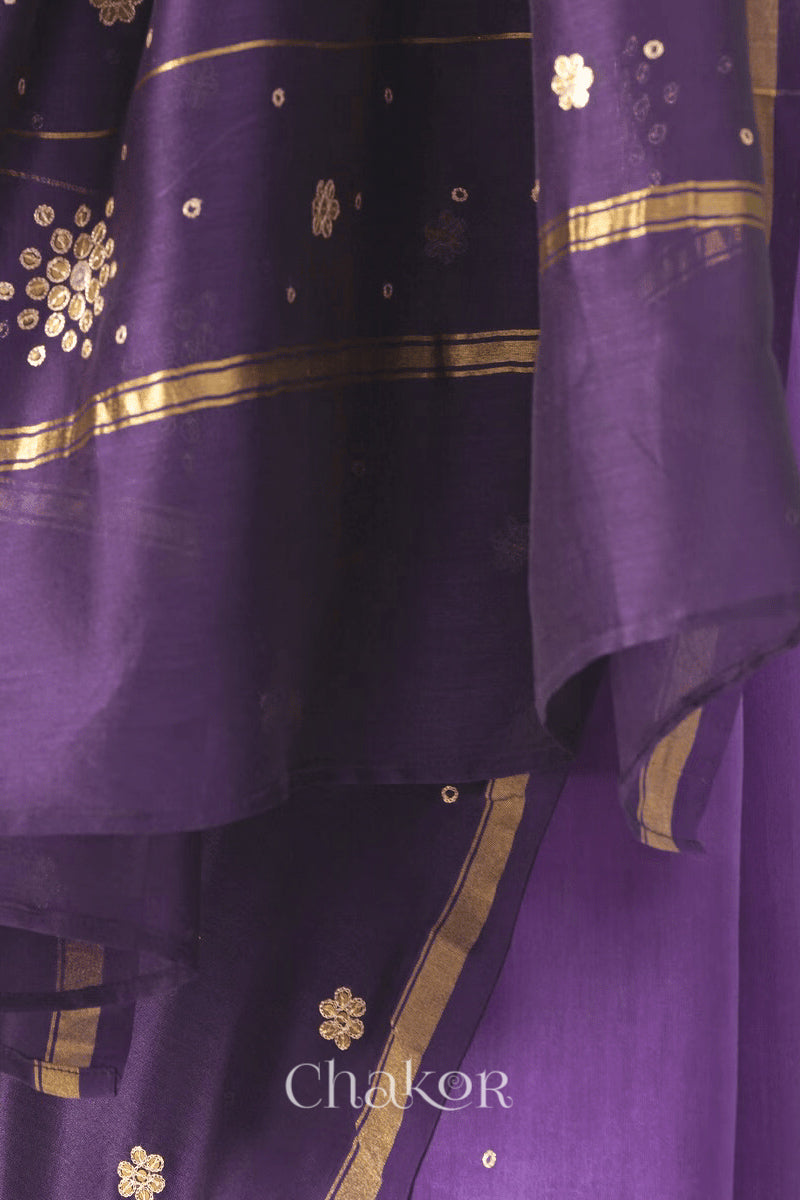 Close-up of hand-embroidered sequin and zari work on violet purple Chanderi silk cotton saree.
