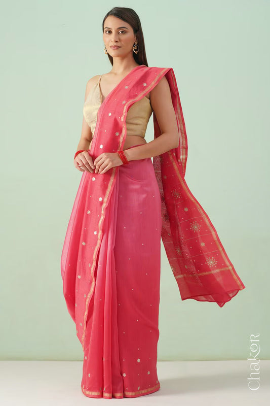 Model wearing a peach red shaded Chanderi silk cotton saree with hand-embroidered sequin and zari details.
