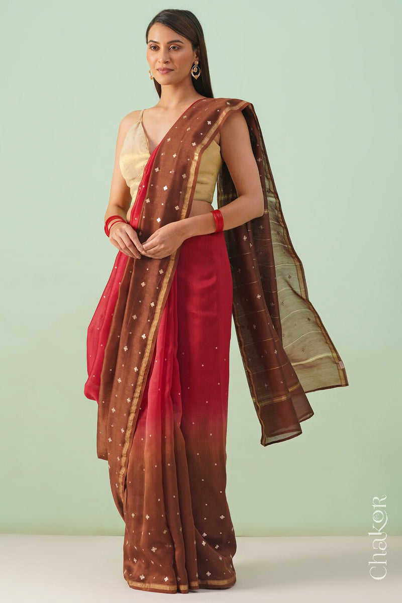 Model wearing a red brown shaded Chanderi silk cotton saree with hand-embroidered sequin and zari details.
