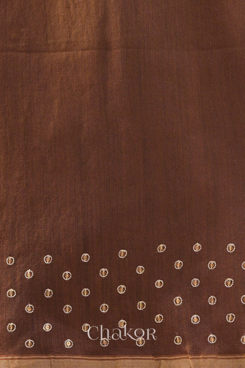 Detail of unstitched blouse piece and scattered sequin embroidery on red brown Chanderi silk cotton saree.
