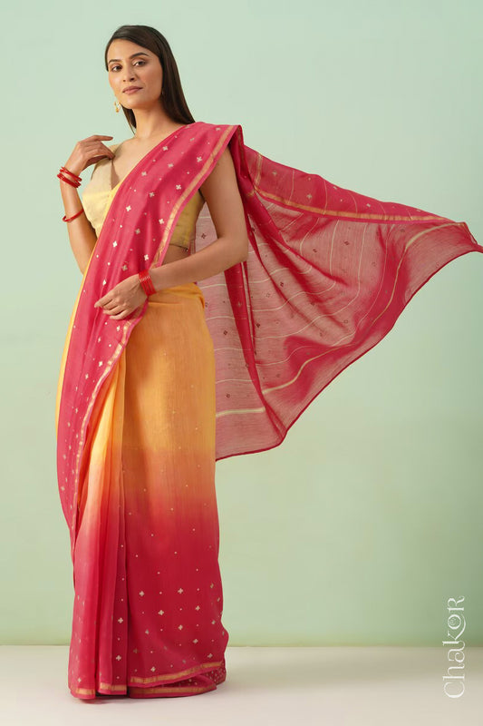 Model wearing a yellow pink shaded Chanderi silk cotton saree with hand-embroidered sequin and zari details.
