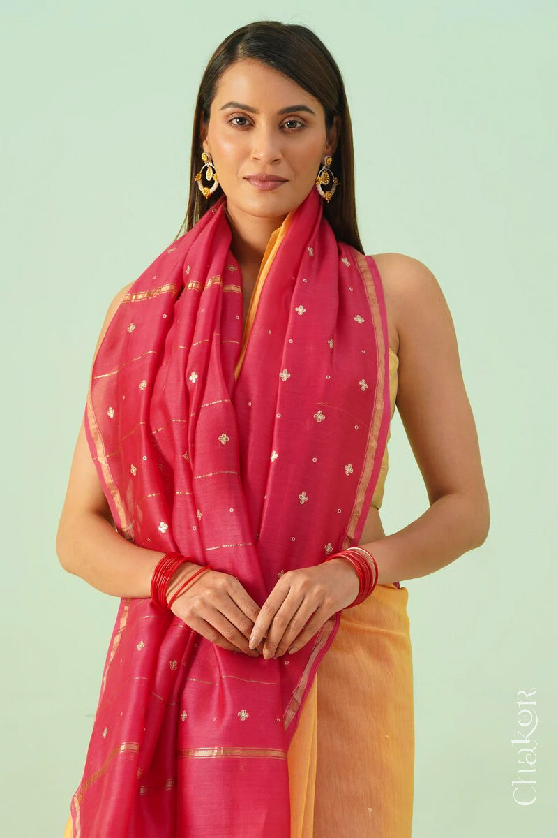 Front close view of yellow pink shaded Chanderi silk cotton saree showing woven body and embroidered details.
