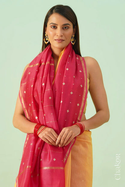 Front close view of yellow pink shaded Chanderi silk cotton saree showing woven body and embroidered details.
