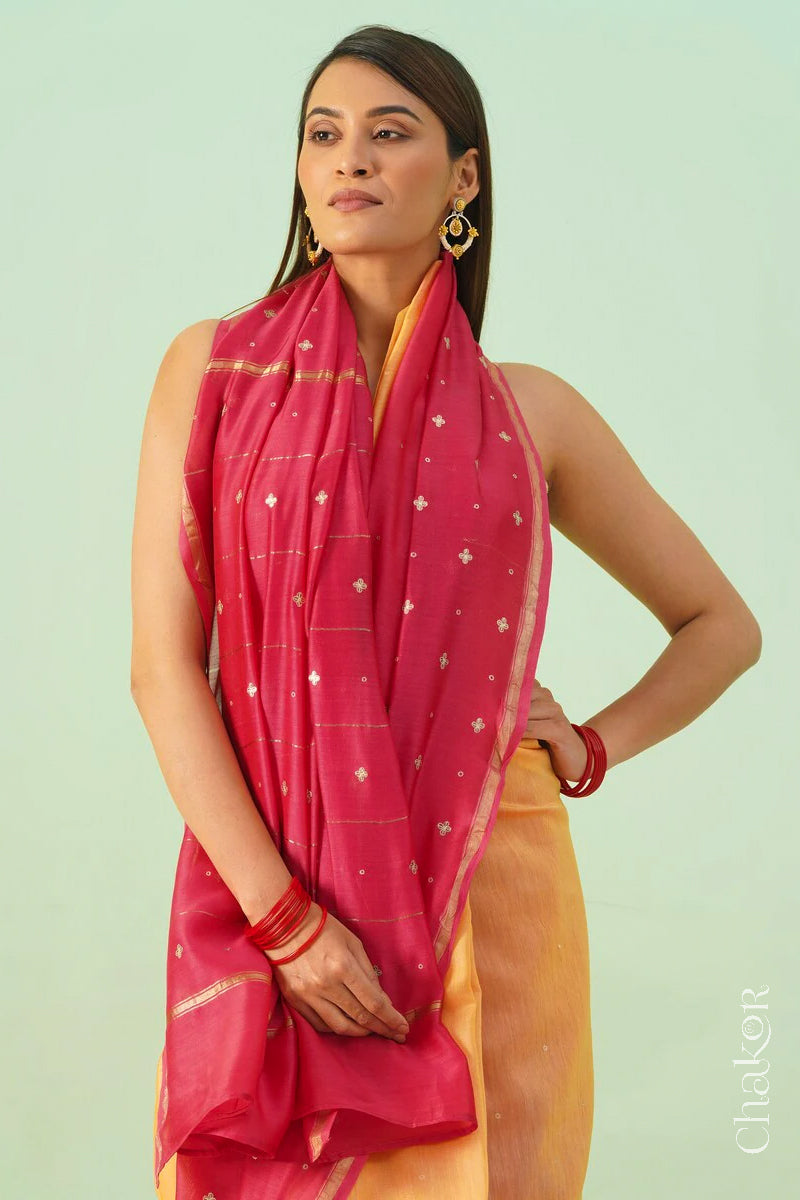 Front close view of yellow pink shaded Chanderi silk cotton saree showing woven body and embroidered details.
