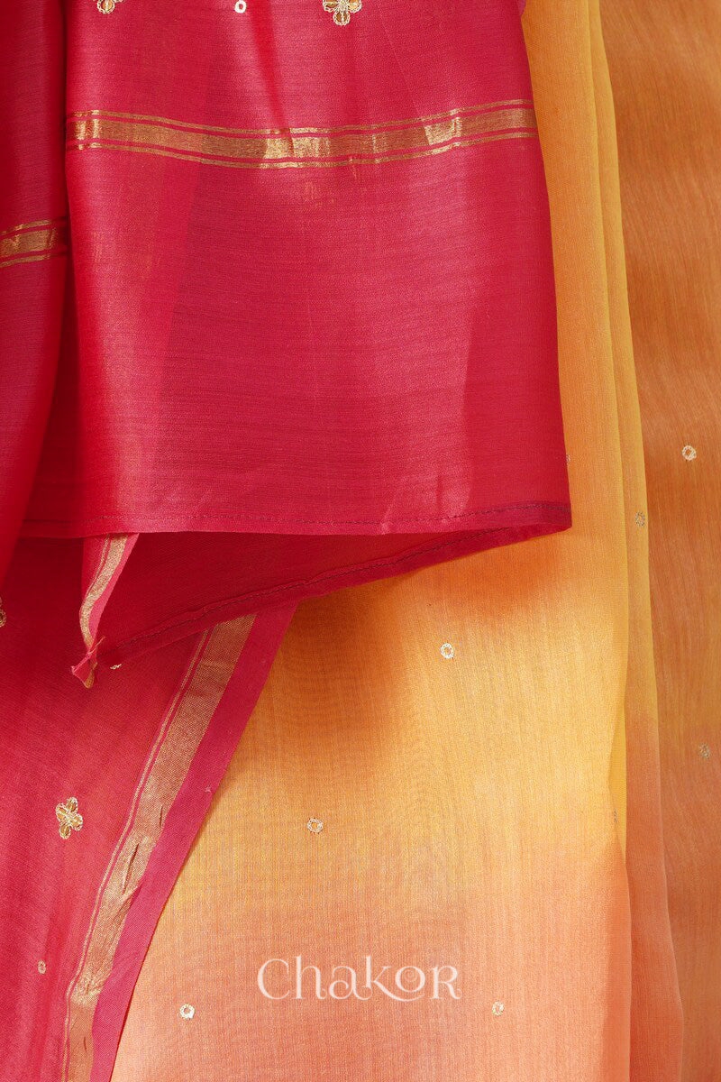 Close-up of hand-embroidered sequin and zari work on yellow pink Chanderi silk cotton saree.
