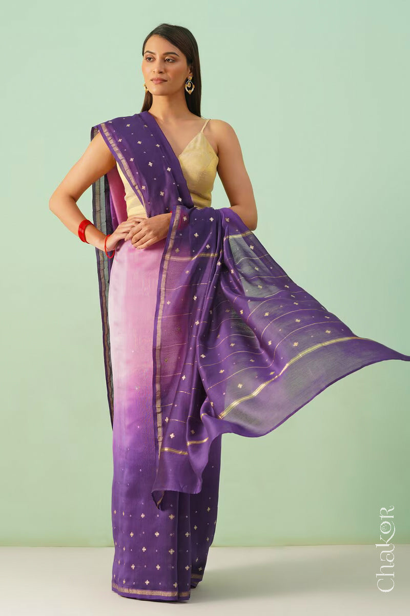 Model wearing a pink purple shaded Chanderi silk cotton saree with hand-embroidered sequin and zari details.
